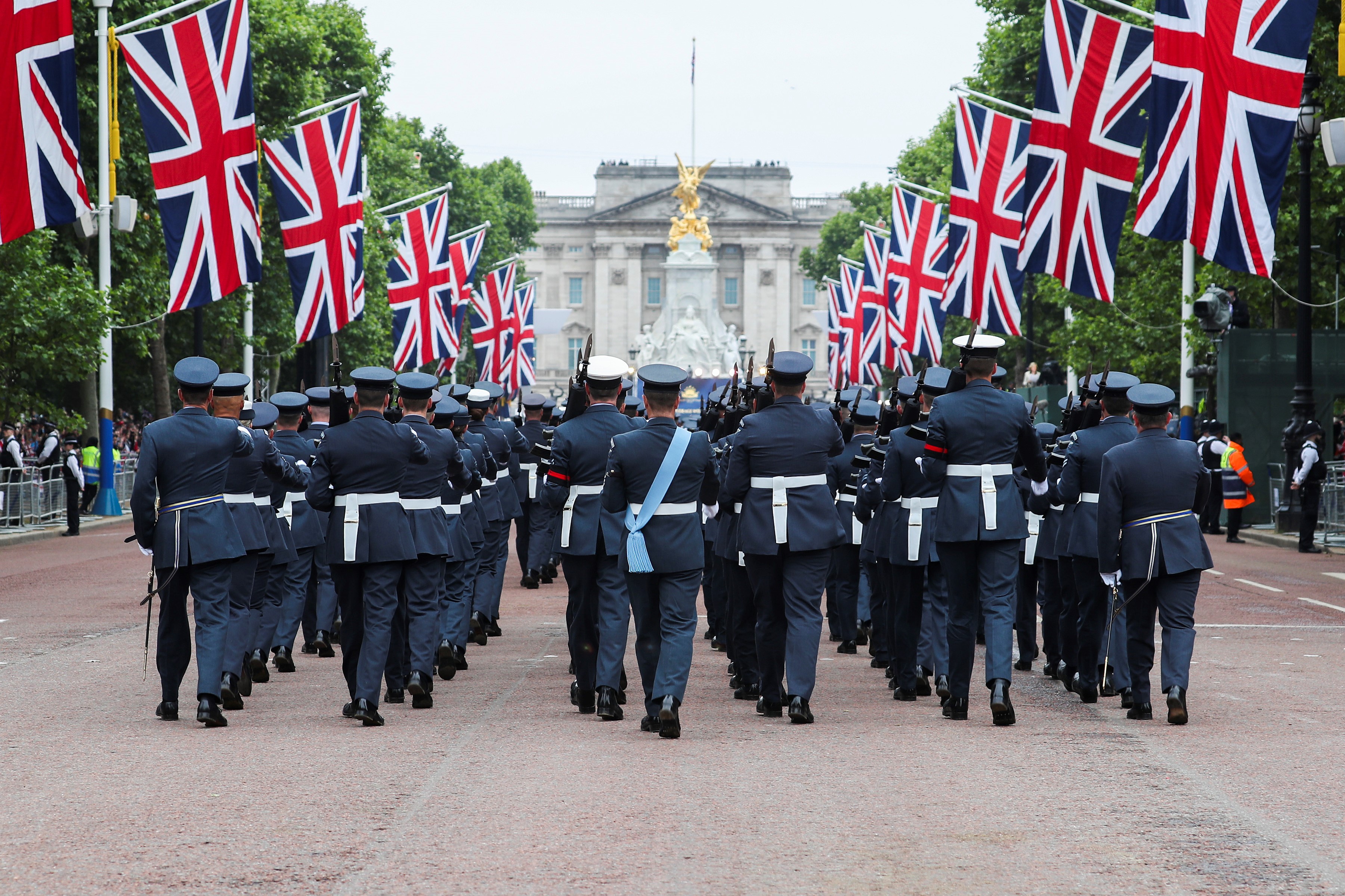 RAF aviators parade The Mall, with Union Jacks. 